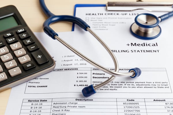 stethoscope sits on healthcare billing statements 118984743