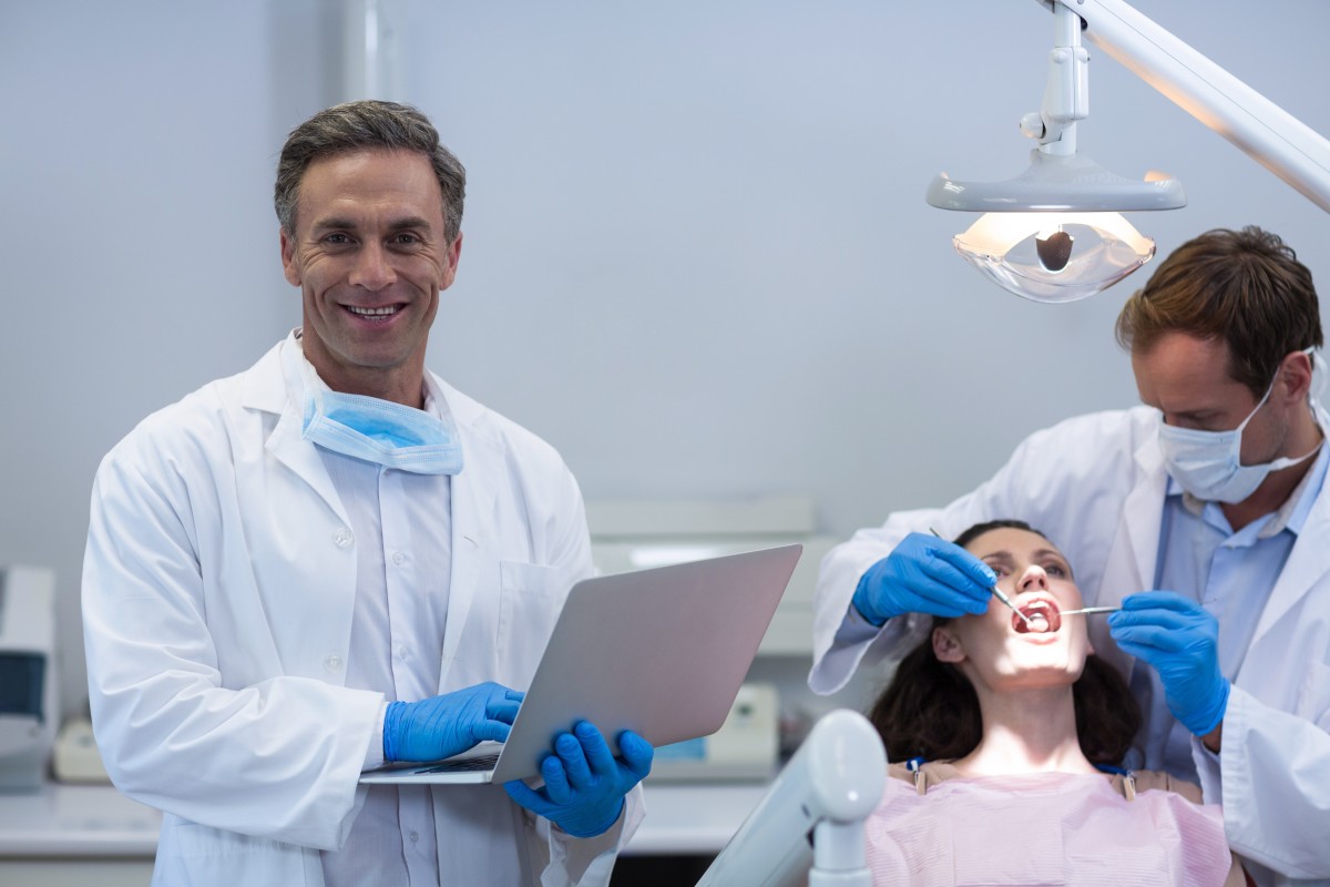dentist using tablet to eprescribe 145113637