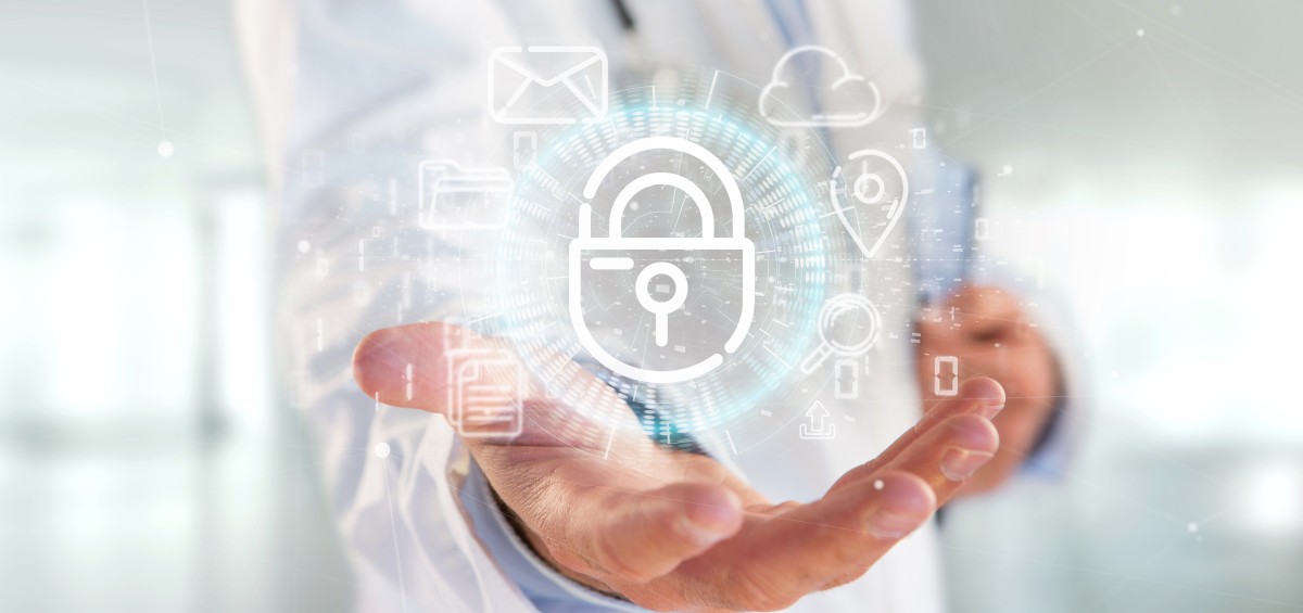 Male healthcare provider's outstretched hand holds a lock with icons around it suggesting healthcare security 247721989