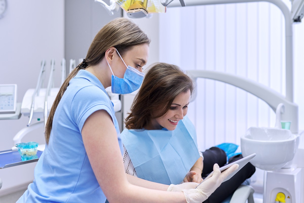 dentist and patient review dental procedures 385850781