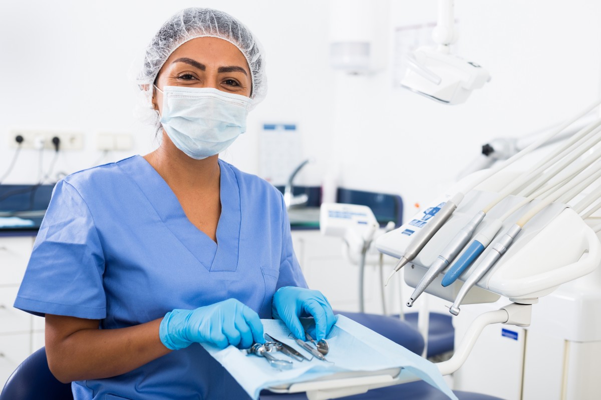 dental tech sits in front of dental tools