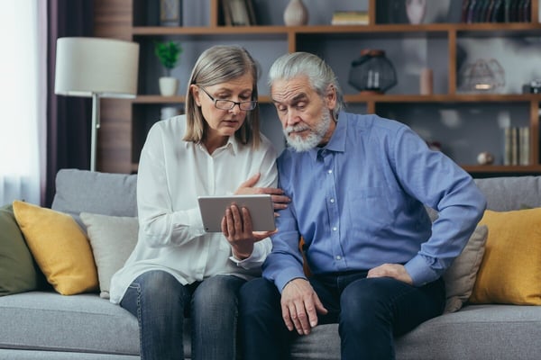 Older couple watches patient education video together 496693117