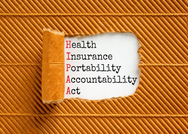 Folder peeled back to reveal HIPAA- Health Insurance Portability Accountability Act 612082839