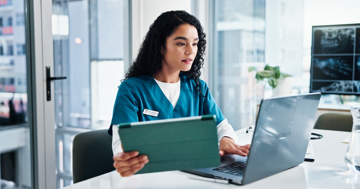 dental practice staff member reviewing predictive practice analytics