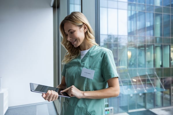 nurse using a tablet and cloud technology in a healthcare practice