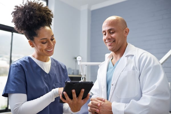 two dental staff members using AI tools